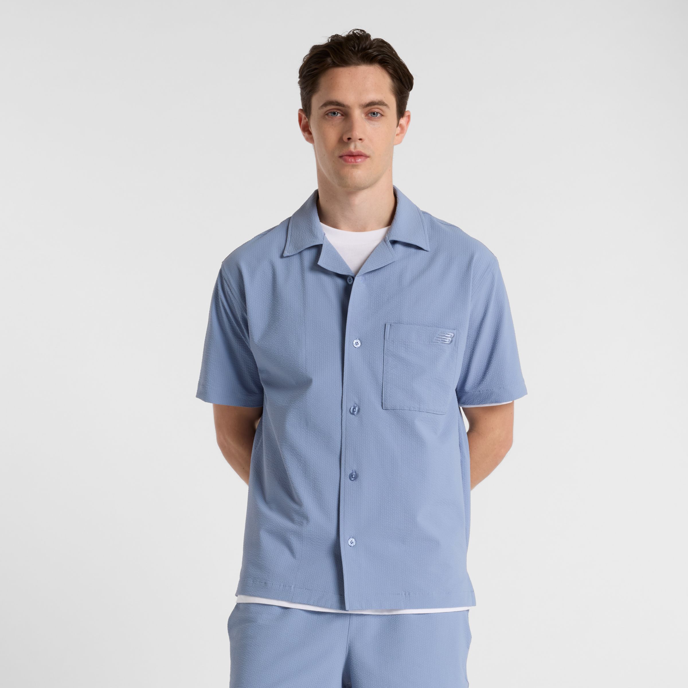 New Balance Uomo Seersucker Button Up Short Sleeve, Politessuto, Taglia L